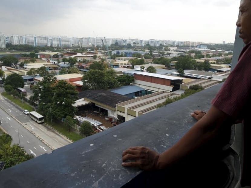 A man looking at a cluster of factories at an industrial park in Singapore.