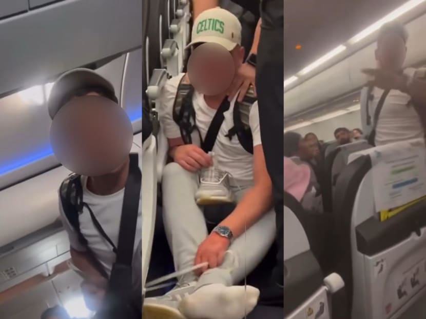 Screenshots from a video where a man can be heard verbally abusing others on a plane and ignoring an announcement by the flight crew for passengers to remain seated.