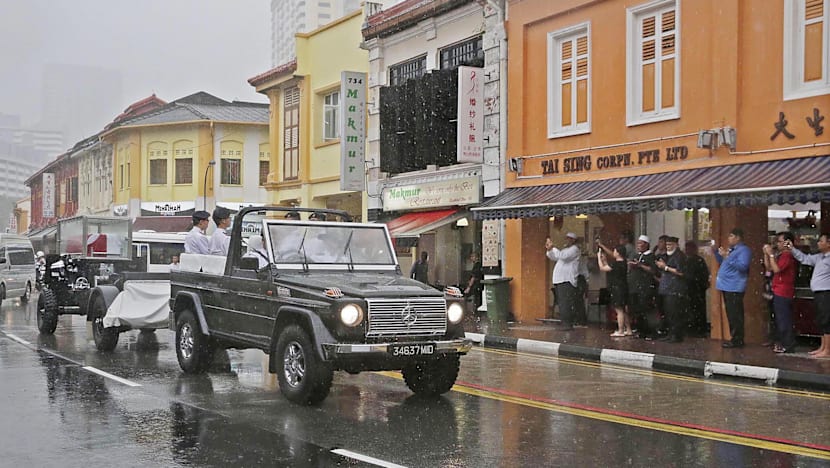 Crowds brave torrential downpour as Othman Wok is laid to rest