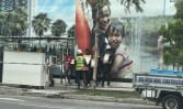 Two to be charged for instructing foreign workers to hold placards in illegal protests