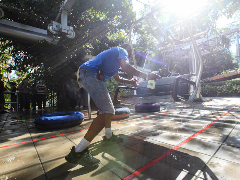 A worker sanitises a cable car at the Escape Theme Park in George Town