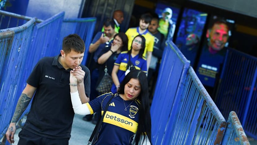 Players and fans join family members at Russo's funeral at Boca stadium