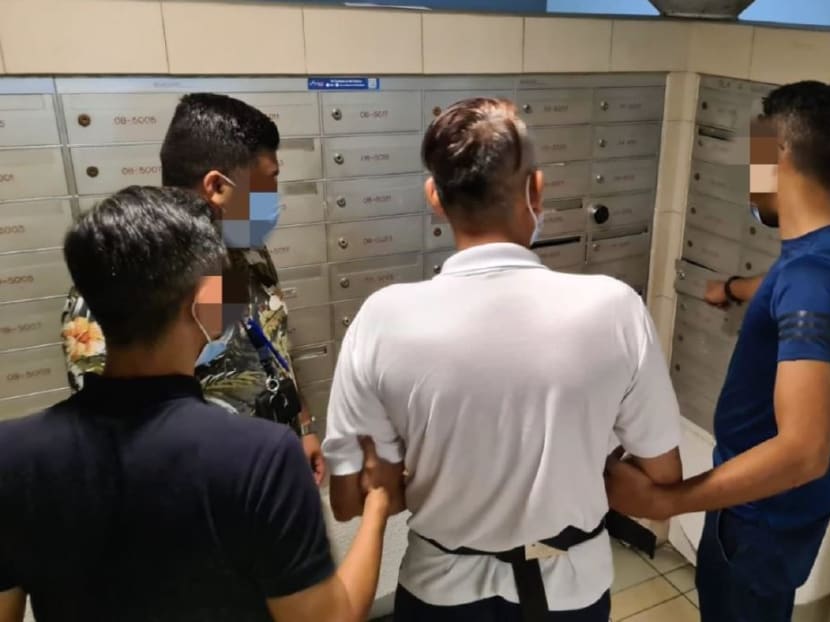 A suspect is escorted by police officers to the crime scene, to identify the letterboxes from which grocery vouchers were allegedly stolen. A suspect is escorted by police officers to the crime scene, to identify the letterboxes from which grocery vouchers were allegedly stolen.
