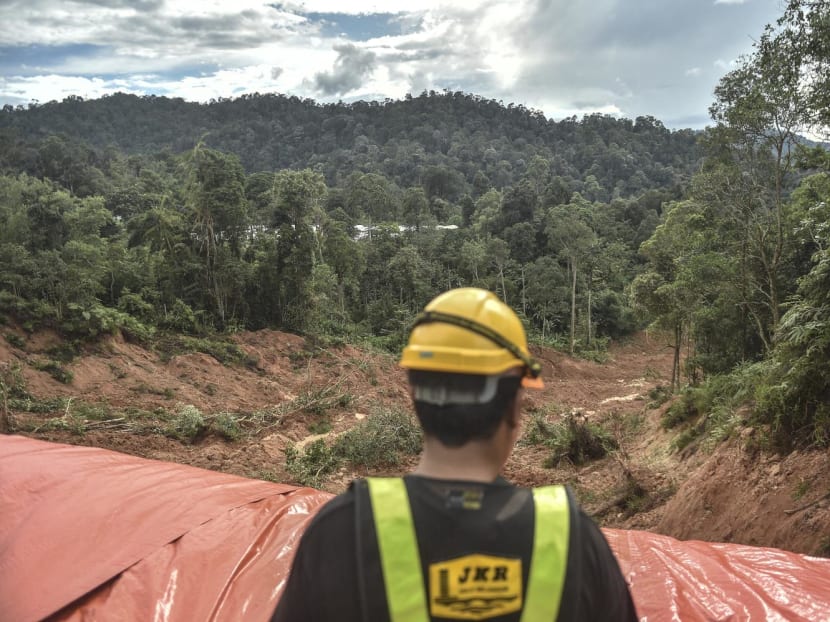 A worker looks at the site damaged after a landslide in Batang Kali, Selangor on Dec 16, 2022. 
