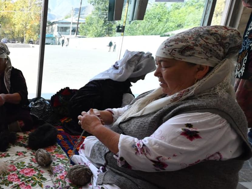 A group of older women calling themselves the "Happy Grandmas" work on weaving Shyrdaks — traditional Kyrgyz woollen rugs, at the House of Culture of the Metallurgists of Kadamjay —  in Kyrgyzstan's remote region of Batken on Oct 2, 2023.