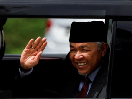 Barisan Nasional President Ahmad Zahid Hamidi waves at photographers as he leaves the National Palace at Kuala Lumpur, Malaysia on Nov 23, 2022.