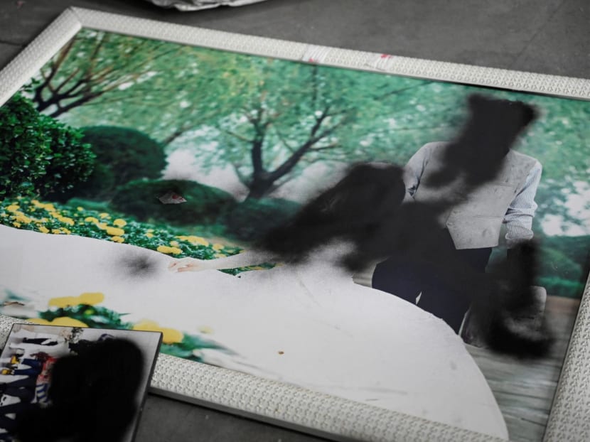 This photo taken on March 27, 2024 shows spray paint covering faces on unwanted wedding photos at a warehouse in Langfang, in northern China's Hebei province.