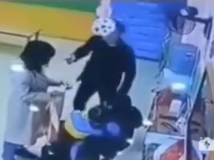 The altercation between the father and the teacher (left) was caught on security camera.