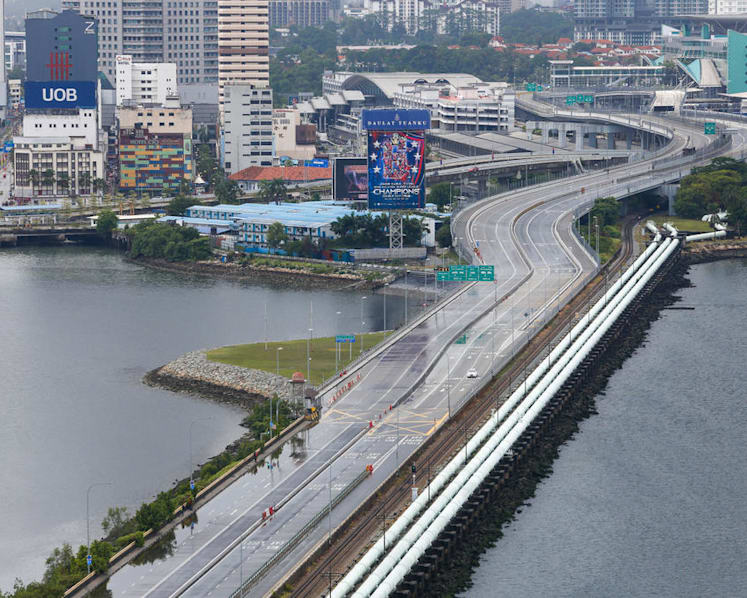 ‘In-principle understanding’ that M’sian work permit holders can enter S’pore during lockdown: Lawrence Wong