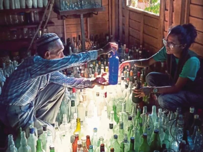 Tengku Mohammad Ali Mansor shows off his bottle collection.