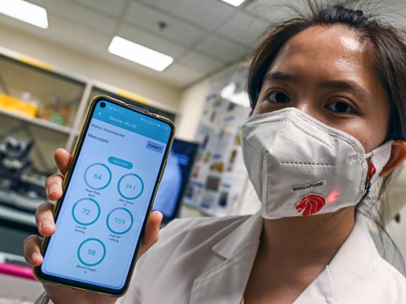 This photograph taken on Sept 16, 2020 shows a research fellow from the School of Materials Science and Engineering at the Nanyang Technology University wearing a face mask installed with sensors which transmit via Bluetooth readings of a person's skin temperature, blood pressure, heart rate and blood oxygen levels to a mobile application in Singapore.