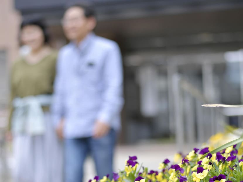 Hiroyuki (R) and Keiko (not their real names) walk side by side in May 2017. The couple got married, the first time for both of them, aged around 50, part of a growing number of people in that age group in Japan who are tying the knot. Photo: Kyodo
