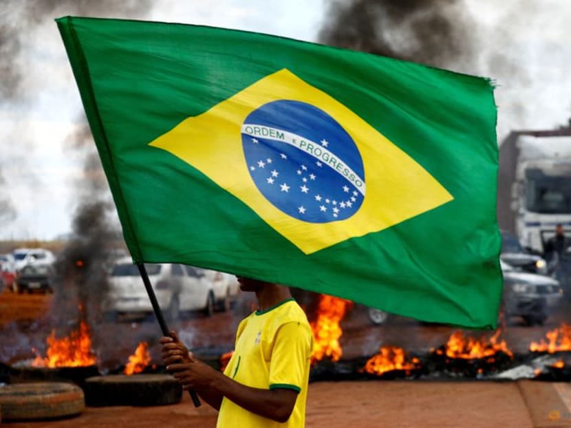 A man holds a Brazilian flag.