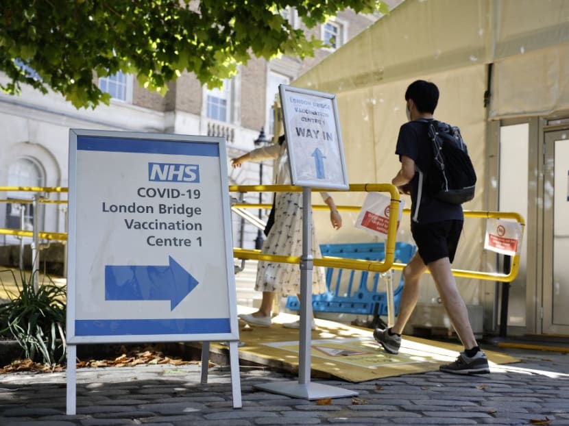 People are directed at the entrance to the London Bridge Vaccination Centre as they arrive to receive doses of the coronavirus Covid-19 vaccine in London on Aug 9, 2021.