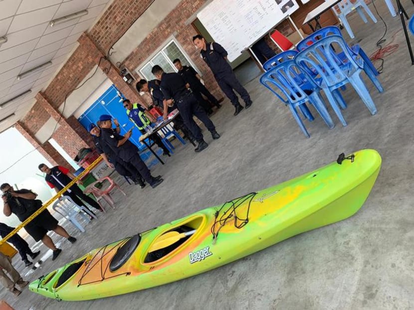 Malaysian officials pictured at Mersing on Aug 14, 2019, with the kayak said to have been used by two missing Singaporeans.