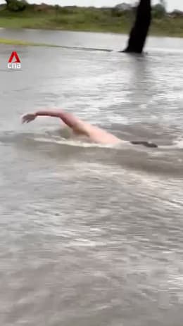 Man swims at flooded Sydney golf course after heavy rain