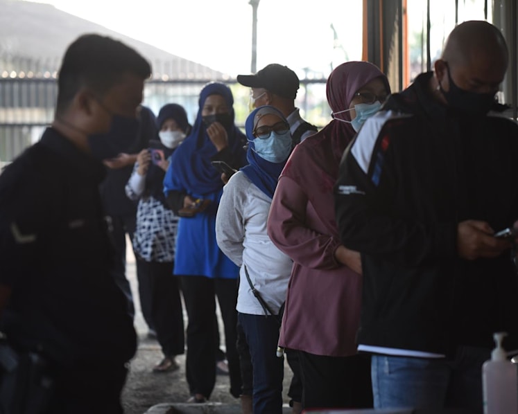 Johor state election: Voters cast their ballots on polling day amid tight COVID-19 protocols 