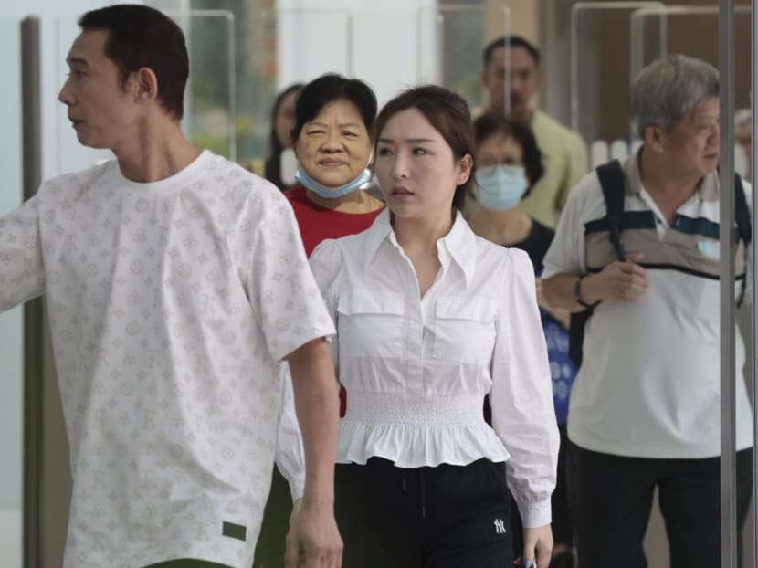 Ding Zhiyan (front, centre) leaving the State Courts on May 14, 2024. Ding Zhiyan (front, centre) leaving the State Courts on May 14, 2024.