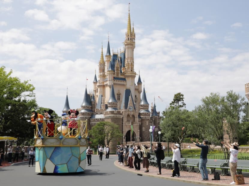 This picture taken on June 29, 2020 shows Disney characters parading past Cinderella Castle during a promotional run for the media at Tokyo Disneyland in Urayasu, Chiba prefecture.