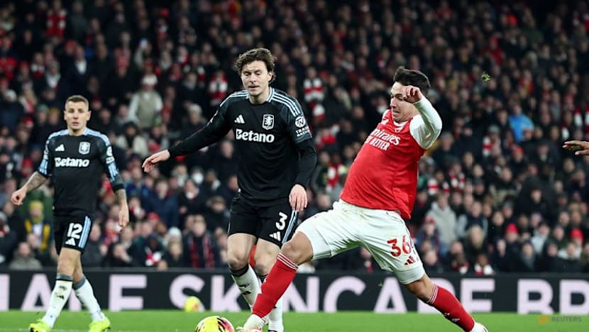 Arsenal halt Villa charge to stay clear in title race