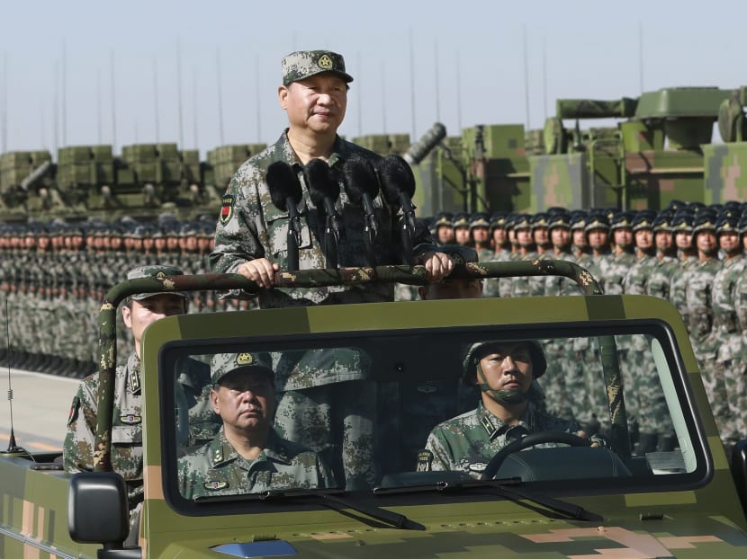 In this photo released by Xinhua News Agency, Chinese President Xi Jinping stands on a military jeep as he inspects troops of the People's Liberation Army during a military parade to commemorate the 90th anniversary of the founding of the PLA at Zhurihe training base in north China's Inner Mongolia Autonomous Region. Photo: AP