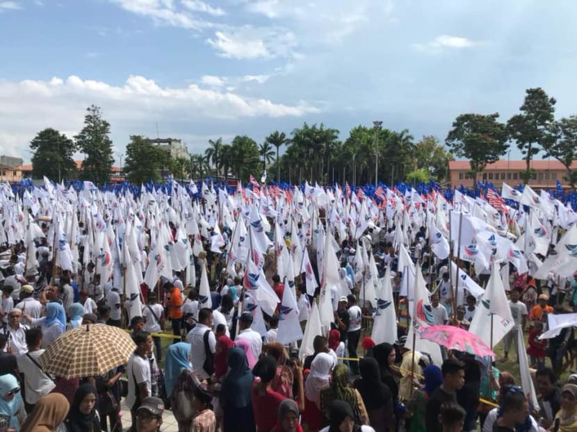 Supporters waving flags of Warisan Sabah, a party led by former federal minister Shafie Apdal. Supporters waving flags of Warisan Sabah, a party led by former federal minister Shafie Apdal.