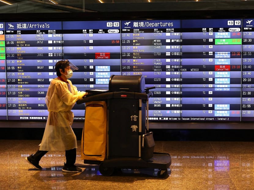 An airport staff member walks past a board showing departure statuses at Taoyuan International Airport in Taoyuan City, Taiwan on Aug 4, 2022. An airport staff member walks past a board showing departure statuses at Taoyuan International Airport in Taoyuan City, Taiwan on Aug 4, 2022.
