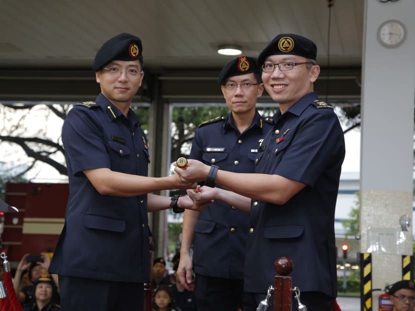 Outgoing Commander 4th SCDF Division COL Ling Young Ern (left) hands over the command mace to incoming Commander LTC Michael Chua (right). The Change of Command Parade was officiated by COMR Eric Yap, Commissioner SCDF (centre). Photo: SCDF