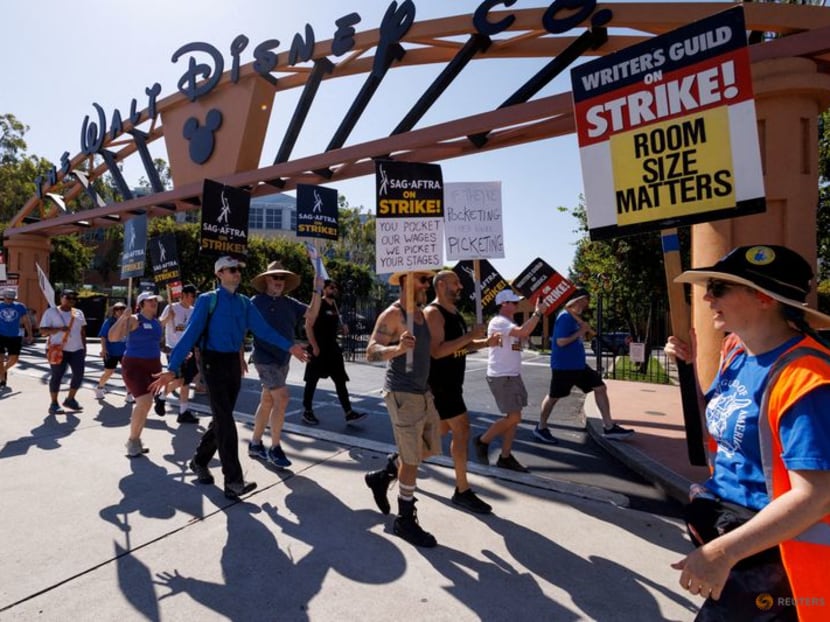 SAG-AFTRA actors and Writers Guild of America (WGA) writers walk the picket line outside Disney Studios in Burbank, California, US, on  July 25, 2023.