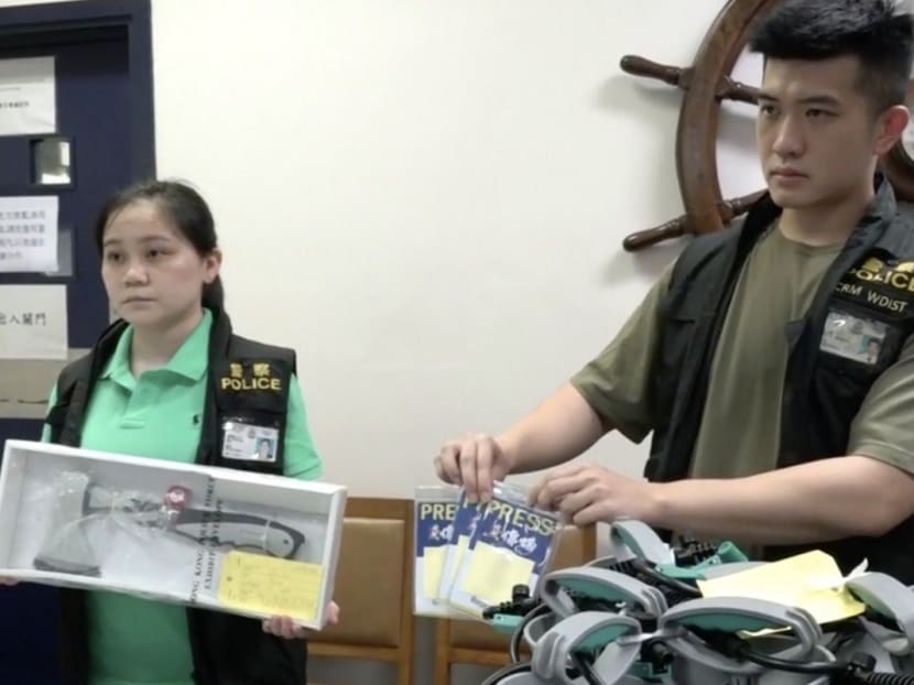 Police show press badges and various other gear confiscated from National Disaster Hardware Shop’s Sai Ying Pun pop-up storefront.