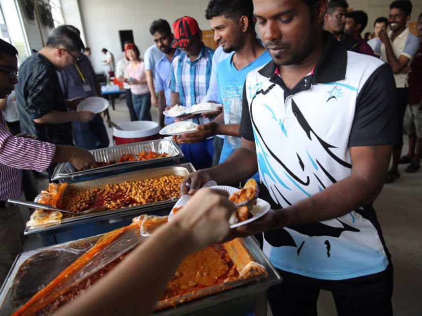 Migrant workers from Tuas View Dormitory standing in line at  to receive a meal with fortified rice. Photo: Don Wong/TODAY