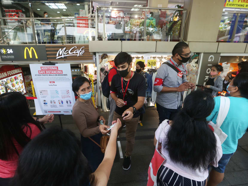 Safe-distancing enforcement officers checking the National Registration Identity Cards and Foreign Identification Numbers of visitors entering Lucky Plaza shopping centre on Sept 6, 2020. Safe-distancing enforcement officers checking the National Registration Identity Cards and Foreign Identification Numbers of visitors entering Lucky Plaza shopping centre on Sept 6, 2020.