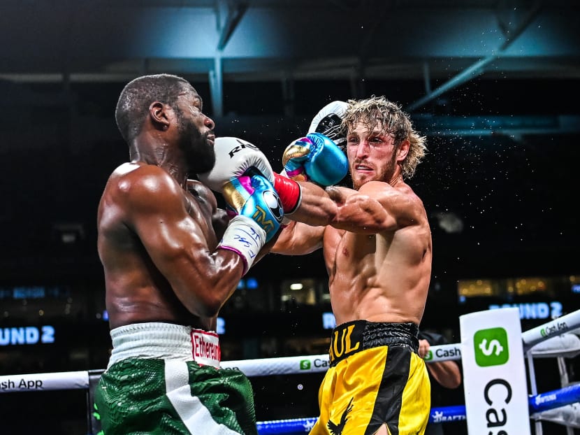 Former world welterweight king Floyd Mayweather (left) and YouTube personality Logan Paul fight in an eight-round exhibition bout at Hard Rock Stadium in Miami, Florida, US on June 6, 2021.