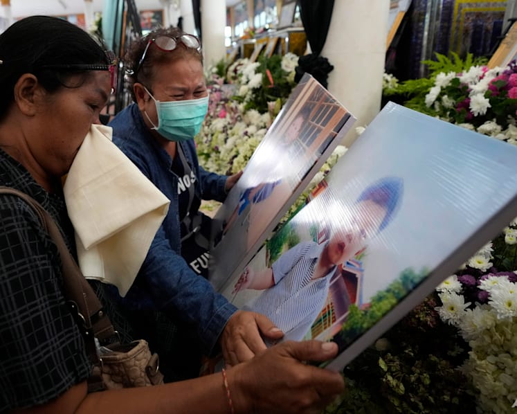 Grieving families pray at Thai temple for slain nursery victims