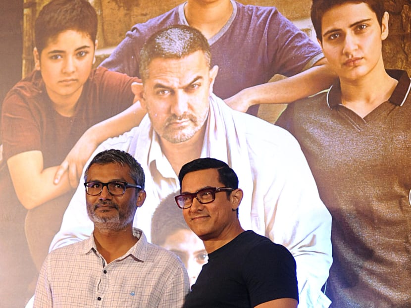 Bollywood actor Aamir Khan (right) during a poster launch in India of his biographical sports drama "Dangal", which was directed by Mr Nitesh Tiwari (left). Photo: AFP