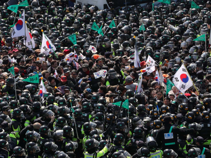 South Koreans jubilant, or stunned by president’s sacking