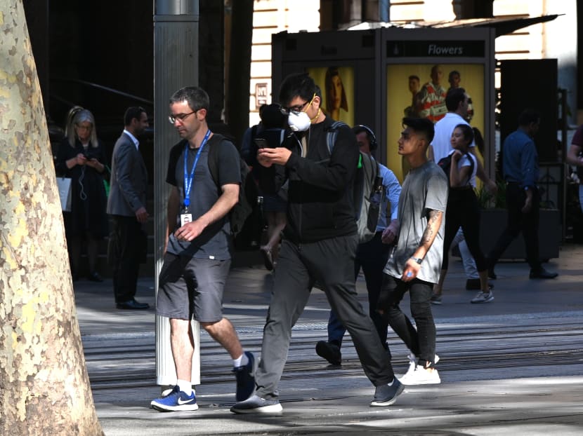 People make their way through streets of the central business district of Sydney on March 12, 2020.
